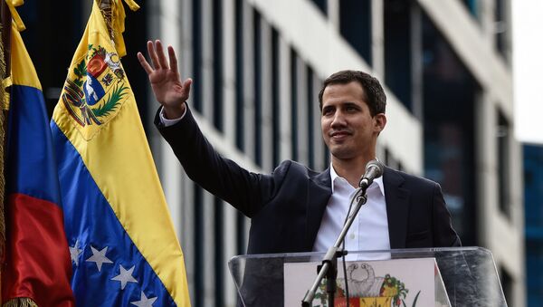 Venezuela's National Assembly head Juan Guaido waves to the crowd during a mass opposition rally against leader Nicolas Maduro in which he declared himself the country's acting president, on the anniversary of a 1958 uprising that overthrew military dictatorship, in Caracas on January 23, 2019. - Sputnik International
