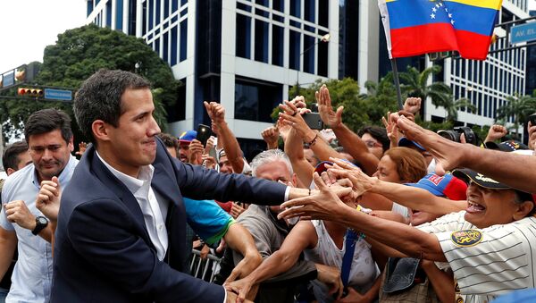 Juan Guaido, President of Venezuela's National Assembly, greets supporters during a rally against Venezuelan President Nicolas Maduro's government and to commemorate the 61st anniversary of the end of the dictatorship of Marcos Perez Jimenez in Caracas, Venezuela January 23, 2019 - Sputnik International