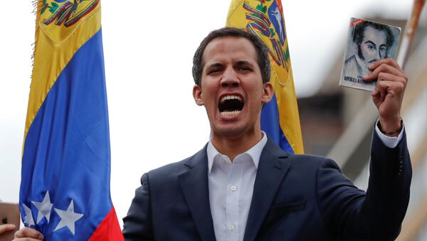 Juan Guaido, President of Venezuela's National Assembly, holds a copy of Venezuelan constitution during a rally against Venezuelan President Nicolas Maduro's government and to commemorate the 61st anniversary of the end of the dictatorship of Marcos Perez Jimenez in Caracas, Venezuela January 23, 2019 - Sputnik International