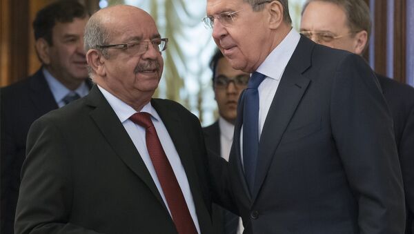 Russian Foreign Minister Sergey Lavrov, right, and Algerian Foreign Affairs Minister Abdelkader Messahel talk to each other as they enter a hall for the talks in Moscow, Russia, Monday, Feb. 19, 2018 - Sputnik International