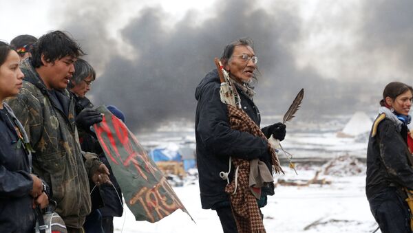 Nathan Phillips (C) marches with other protesters out of the main opposition camp against the Dakota Access oil pipeline near Cannon Ball, North Dakota, U.S., February 22, 2017. Picture taken February 22, 2017 - Sputnik International