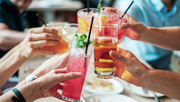 Table of adults cheers, toast over dinner with alcoholic drinks  - Sputnik International