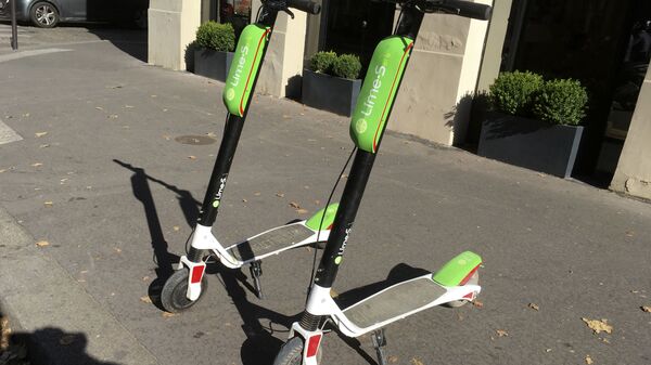 This July 3, 2018, photo shows scooters by Lime in Paris. Uber is getting into the scooter-rental business. The ride-hailing company said Monday, July 9, that it is investing in Lime, a startup based in San Mateo, California.  - Sputnik International