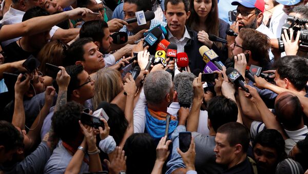 Venezuelan opposition leader and self-proclaimed interim president Juan Guaido accompanied by his wife Fabiana Rosales, speaks to the media after a holy Mass at a local church in Caracas, Venezuela, January 27, 2019 - Sputnik International