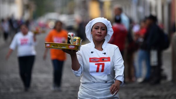 A waitress participates in the XVI Carrera de Charolas (Waiters Race) in Antigua Guatemala,45 km southwest of Guatemala City, on November 14, 2018. - Sputnik International