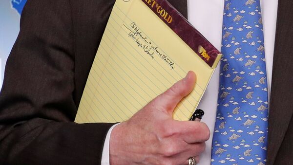 U.S. National Security Adviser John Bolton holds a writing pad with a written note that reads 5,000 troops to Colombia, while he waits to address reporters, as the Trump administration announces economic sanctions against Venezuela and the Venezuelan state owned oil company Petroleos de Venezuela (PdVSA) during a press briefing at the White House in Washington, U.S., January 28, 2019 - Sputnik International