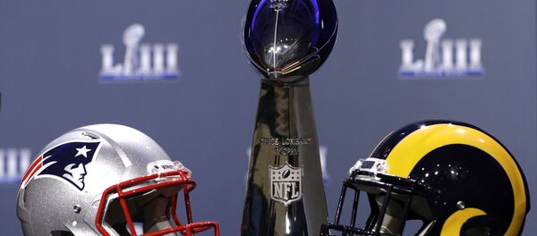 The helmets of the New England Patriots and the Los Angeles Rams next to the Superbowl trophy The helmets of the New England Patriots and the Los Angeles Rams next to the Superbowl trophy - Sputnik International