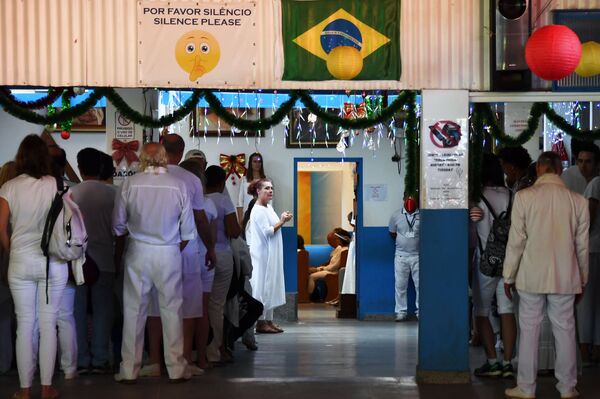 Followers of Brazilian spiritual healer Joao Teixeira de Faria, known as Joao de Deus (John of God), wait for their turn to be attended, at Faria's healing center Casa de Dom Inacio de Loyola, in Abadiania, 120 km southwest of Brasilia, state of Goias on December 12, 2018. Followers of Brazilian spiritual healer Joao Teixeira de Faria, known as Joao de Deus (John of God), wait for their turn to be attended, at Faria's healing center Casa de Dom Inacio de Loyola, in Abadiania, 120 km southwest of Brasilia, state of Goias on December 12, 2018. - Sputnik International
