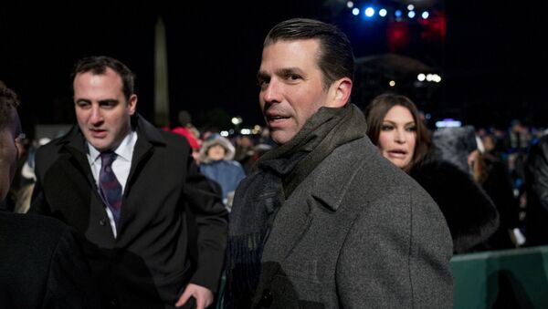 Donald Trump Jr., center, and Kimberly Guilfoyle, right, depart following the National Christmas Tree lighting ceremony at the Ellipse near the White House in Washington. File photo - Sputnik International