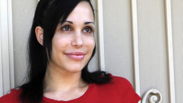 In this May 19, 2010 this file photo, Nadya Suleman stands outside her home in La Habra, Calif. Much has transpired since Suleman became Octomom by giving birth to eight premature but otherwise healthy children on Jan. 26, 2009. She's gone from medical marvel to national punch line for her various money-generating efforts. Hers are the only known full set of octuplets to live past their first week. - Sputnik International