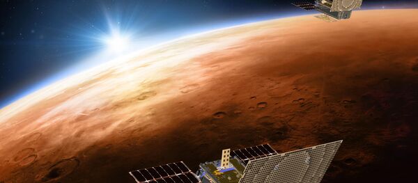 This illustration made available by NASA on March 29, 2018 shows the twin Mars Cube One (MarCO) spacecraft flying over Mars with Earth and the sun in the distance This illustration made available by NASA on March 29, 2018 shows the twin Mars Cube One (MarCO) spacecraft flying over Mars with Earth and the sun in the distance - Sputnik International
