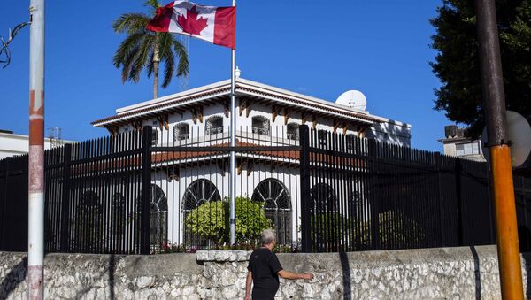 FILE - In this April 17, 2018 file photo, a man walks beside Canada's embassy in Havana, Cuba - Sputnik International