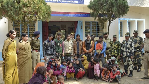 Indian police officials stand next to Rohingya Muslims after they were arrested in two northeastern states, outside a police station in Agartala, India, Tuesday, Jan. 22, 2019 - Sputnik International