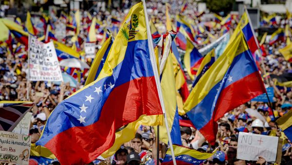 Supporters of Juan Guaido, self-proclaimed Interim President of Venezuela, wave flag during a rally, in Caracas, Venezuela - Sputnik International