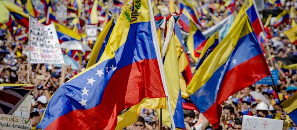 Supporters of Juan Guaido, self-proclaimed Interim President of Venezuela, wave flag during a rally, in Caracas, Venezuela - Sputnik International