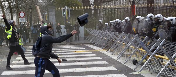 A protestor throws an object at a police line during a demonstration in Brussels, Saturday, Dec. 8, 2018. - Sputnik International