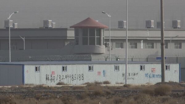 a guard tower and barbed wire fences around a facility in the Kunshan Industrial Park in Artux in western China's Xinjiang region, one of a growing number of internment camps in the region, where by some estimates 1 million Muslims are detained, forced to give up their language and their religion and subject to political indoctrination - Sputnik International