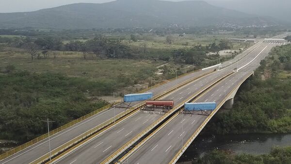 This image taken from video, shows a fuel tanker, cargo trailers and makeshift fencing, blocking the Tienditas International Bridge in an attempt to stop humanitarian aid entering from Colombia, as seen from the outskirts of Cucuta, on Colombia's border with Venezuela, Wednesday, Feb. 6, 2019. Immigration authorities say the Venezuelan National Guard built the roadblock a day earlier. - Sputnik International