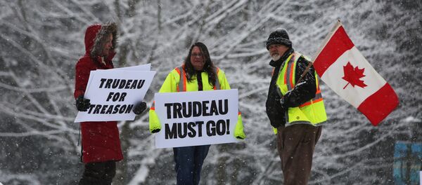 Protesters hold signs as Canada's Prime Minister Justin Trudeau campaigns with Liberal candidate for Burnaby South riding Richard T. Lee in Burnaby, B.C., Canada, 10 February , 2019 Protesters hold signs as Canada's Prime Minister Justin Trudeau campaigns with Liberal candidate for Burnaby South riding Richard T. Lee in Burnaby, B.C., Canada, 10 February , 2019 - Sputnik International