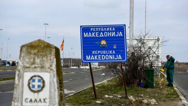 Workers clean up near the sign at the border between Macedonia and Greece, near Gevgelija, on February 11, 2019. - Sputnik International