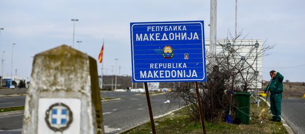Workers clean up near the sign at the border between Macedonia and Greece, near Gevgelija, on February 11, 2019. Workers clean up near the sign at the border between Macedonia and Greece, near Gevgelija, on February 11, 2019. - Sputnik International