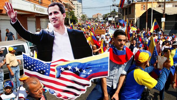 Opposition supporters carrying a cardboard cut-out of Venezuelan opposition leader Juan Guaido take part in a rally against Venezuelan President Nicolas Maduro's government and to commemorate the Day of the Youth in Maracaibo, Venezuela February 12, 2019. - Sputnik International
