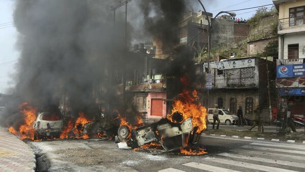 Vehicles stand in flames after it was set on fire by a mob during a protest against Thursday's attack on a paramilitary convoy, in Jammu, India, Friday, Feb.15, 2019 - Sputnik International