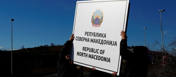 Workers set up a sign with Macedonia's new name at the border between Macedonia and Greece Workers set up a sign with Macedonia's new name at the border between Macedonia and Greece - Sputnik International