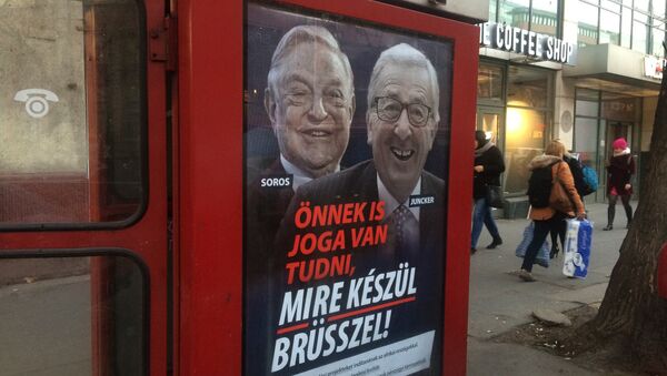 A phone box displays a billboards showing Hungarian-American financier George Soros and EU Commission President Jean-Claude Juncker above the caption “You have a right to know what Brussels is preparing to do!, on Vaci Avenue in Budapest, Hungary, Tuesday, Feb. 19, 2019 - Sputnik International
