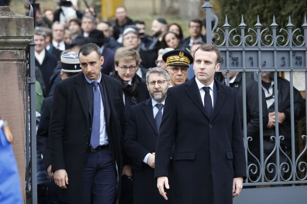 French President Emmanuel Macron, right, with France's Chief Rabbi Haim Korsia, center, leave the Jewish cemetery where tombs were tagged with swastikas in Quatzenheim, eastern France, Tuesday, Feb.19, 2019. French President Emmanuel Macron, right, with France's Chief Rabbi Haim Korsia, center, leave the Jewish cemetery where tombs were tagged with swastikas in Quatzenheim, eastern France, Tuesday, Feb.19, 2019. - Sputnik International