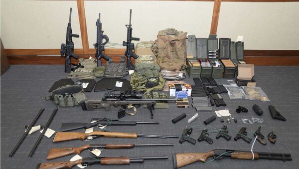 This image provided by the U.S. District Court in Maryland shows a photo of firearms and ammunition that was in the motion for detention pending trial in the case against Christopher Paul Hasson. Prosecutors say that Hasson, a Coast Guard lieutenant is a domestic terrorist who wrote about biological attacks and had a hit list that included prominent Democrats and media figures. He is due in court on Feb. 21 in Maryland. Prosecutors say Hasson espoused extremist views for years. Court papers say Hasson described an interesting idea in a 2017 draft email that included biological attacks followed by attack on food supply. - Sputnik International