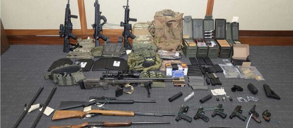 This image provided by the U.S. District Court in Maryland shows a photo of firearms and ammunition that was in the motion for detention pending trial in the case against Christopher Paul Hasson. Prosecutors say that Hasson, a Coast Guard lieutenant is a domestic terrorist who wrote about biological attacks and had a hit list that included prominent Democrats and media figures. He is due in court on Feb. 21 in Maryland. Prosecutors say Hasson espoused extremist views for years. Court papers say Hasson described an interesting idea in a 2017 draft email that included biological attacks followed by attack on food supply. - Sputnik International