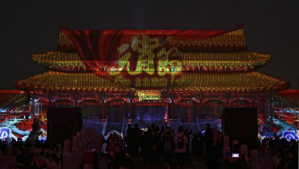 Visitors tour the Forbidden City projected with colorful lights during the Lantern Festival in Beijing, Tuesday, Feb. 19, 2019. Beijing's Palace Museum was illuminated and opened for night visits to celebrate China's Lantern Festival. - Sputnik International