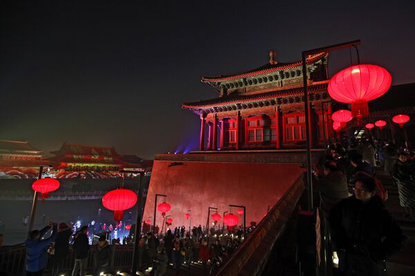 Visitors tour the Forbidden City decorated with red lanterns and illuminated with lights during the Lantern Festival in Beijing, Tuesday, Feb. 19, 2019. - Sputnik International