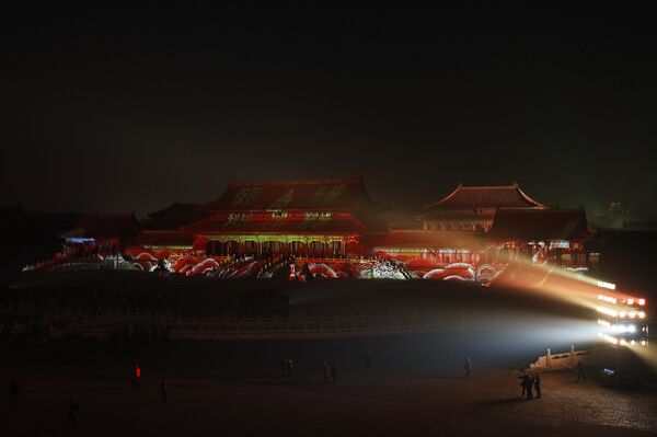 Visitors tour the Forbidden City projected with colorful lights during the Lantern Festival in Beijing, Tuesday, Feb. 19, 2019. - Sputnik International