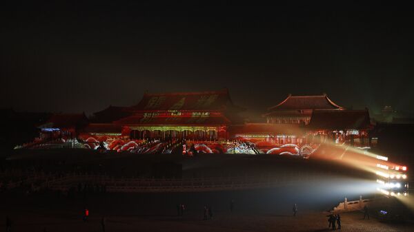 Visitors tour the Forbidden City projected with colorful lights during the Lantern Festival in Beijing, Tuesday, Feb. 19, 2019. - Sputnik International
