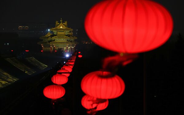 In this Tuesday, Feb. 19, 2019, photo, lanterns is decorated near a Turret of the Forbidden City projected with lights for the Lantern Festival in Beijing. - Sputnik International