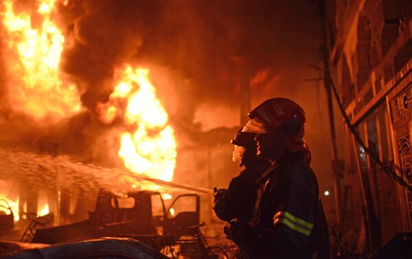 In this Wednesday, Feb. 20, 2019, photo, firefighters try to douse a fire in Dhaka, Bangladesh. - Sputnik International