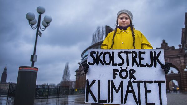 Swedish 15-year-old girl Greta Thunberg holds a placard reading School strike for the climate during a protest against climate change outside the Swedish parliament on November 30, 2018 - Sputnik International