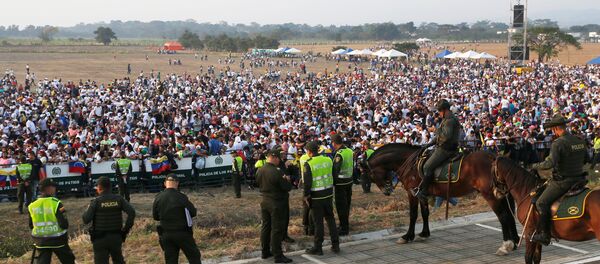 Police officers stand guard as people attend the Venezuela Aid Live concert near the Tienditas cross-border bridge between Colombia and Venezuela, in Cucuta, Colombia, February 22, 2019. - Sputnik International