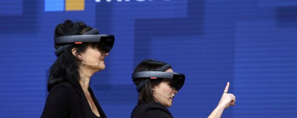 FILE- In this May 11, 2017, file photo, members of a design team at Cirque du Soleil demonstrate use of Microsoft's HoloLens device in helping to virtually design a set at the Microsoft Build 2017 developers conference in Seattle. Federal contract records show the U.S. Army has awarded Microsoft a $480 million contract to supply its HoloLens headsets to soldiers. The head-mounted displays use augmented reality, which means viewers can see virtual imagery superimposed over the real-world scenery in front of them. Microsoft says the technology will provide troops with better information to make decisions FILE- In this May 11, 2017, file photo, members of a design team at Cirque du Soleil demonstrate use of Microsoft's HoloLens device in helping to virtually design a set at the Microsoft Build 2017 developers conference in Seattle. Federal contract records show the U.S. Army has awarded Microsoft a $480 million contract to supply its HoloLens headsets to soldiers. The head-mounted displays use augmented reality, which means viewers can see virtual imagery superimposed over the real-world scenery in front of them. Microsoft says the technology will provide troops with better information to make decisions - Sputnik International