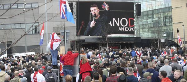 Former leader and founder of the English Defence League, Tommy Robinson seen on screen, as he addresses an EDL protest over a TV program, outside the BBC building in Salford, England, Saturday Feb. 23, 2019. - Sputnik International
