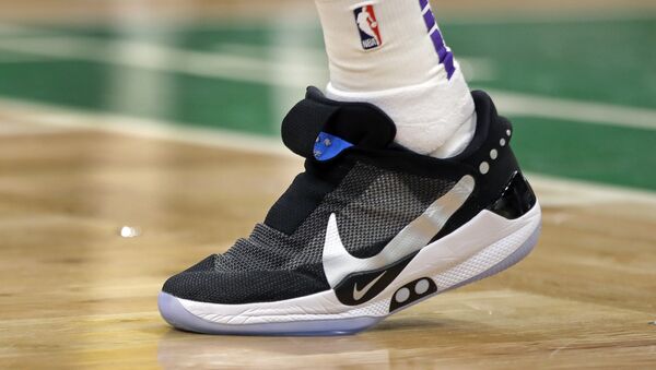 In this Feb. 7, 2019, photo, Los Angeles Lakers forward Kyle Kuzma walks on the court during an NBA basketball game against the Boston Celtics in Boston. He is wearing Nike's latest performance basketball shoes, which from concept to reality, took about three years to put together. Or 30 years, depending on how you count. The Nike Adapt BB _ a self-lacing smart shoe that can be controlled by a smartphone _ gets released to the public on Sunday, Feb. 17, 2019, a date that just happens to coincide with the NBA All-Star Game in Charlotte. It has a motor embedded within the shoe, and a hefty $350 price tag. - Sputnik International