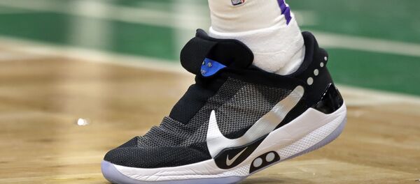 In this Feb. 7, 2019, photo, Los Angeles Lakers forward Kyle Kuzma walks on the court during an NBA basketball game against the Boston Celtics in Boston. He is wearing Nike's latest performance basketball shoes, which from concept to reality, took about three years to put together. Or 30 years, depending on how you count. The Nike Adapt BB _ a self-lacing smart shoe that can be controlled by a smartphone _ gets released to the public on Sunday, Feb. 17, 2019, a date that just happens to coincide with the NBA All-Star Game in Charlotte. It has a motor embedded within the shoe, and a hefty $350 price tag. - Sputnik International