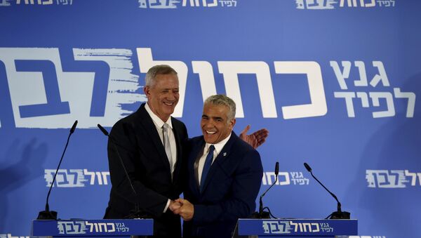 Retired Israeli military chief Benny Gantz, left, smiles with Yair Lapid, head of the Yesh Atid party as they launch joint list for the upcoming Israeli elections in Tel Aviv, Israel, Thursday, Feb. 21, 2019 - Sputnik International