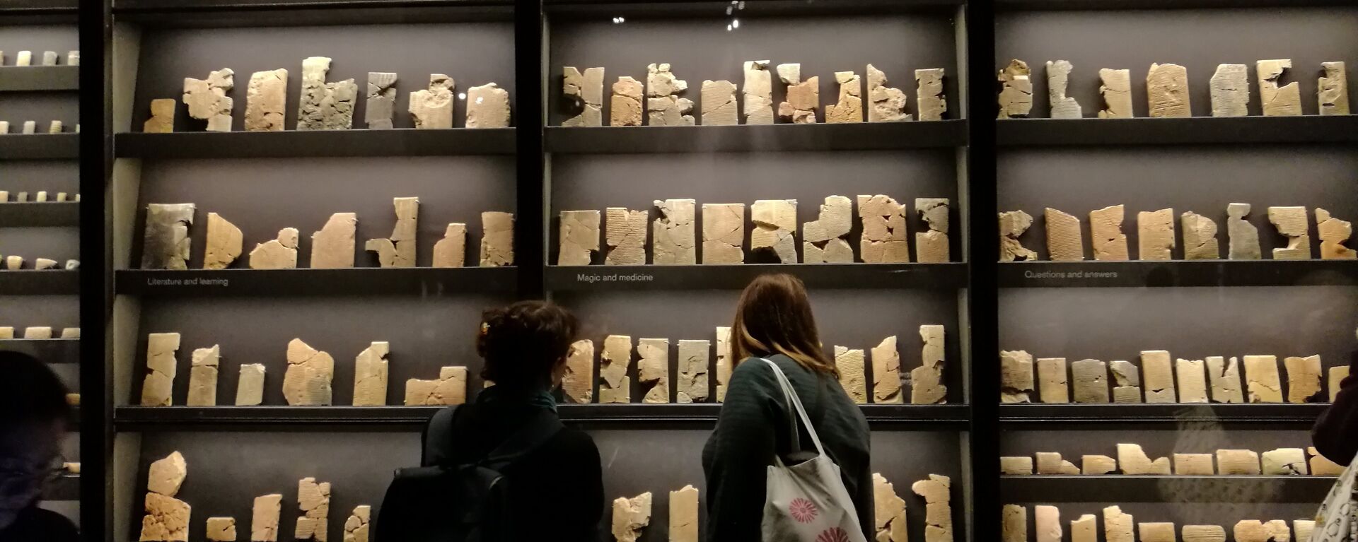 Visitors walk past a collection of 7th-century cuneiform texts from Ashurbanipal's personal library. - Sputnik International, 1920, 04.05.2023