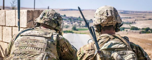 Two US soldiers keep an eye on the demarcation line during a security patrol outside Manbij, Syria, 26 June, 2018 - Sputnik International