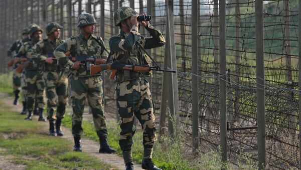 India's Border Security Force (BSF) soldiers patrol along the fenced border with Pakistan in Ranbir Singh Pura sector near Jammu February 26, 2019 - Sputnik International