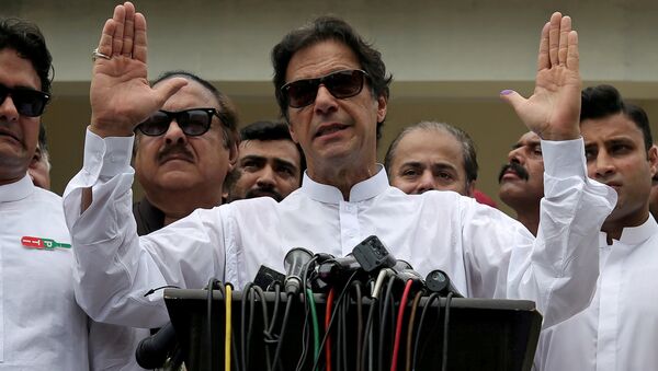 Cricket star-turned-politician Imran Khan, chairman of Pakistan Tehreek-e-Insaf (PTI), speaks after voting in the general election in Islamabad, July 25, 2018 - Sputnik International