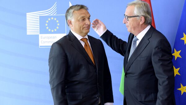 Hungary's Prime Minister Viktor Orban (L) is greeted by European Union Commission President Jean-Claude Juncker of Luxembourg prior to their meeting at the European Union Commission headquarter in Brussels on September 3, 2015 - Sputnik International